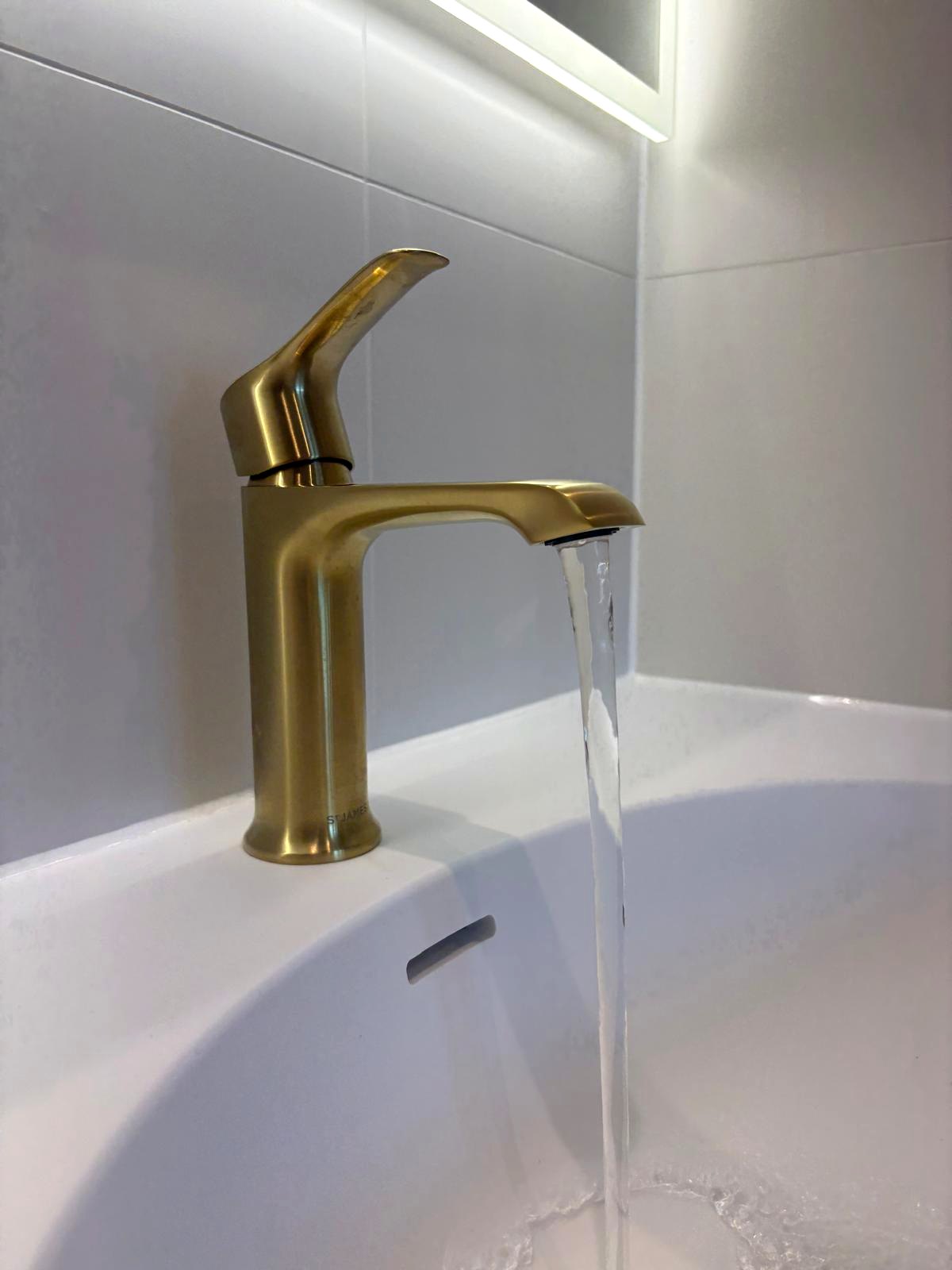 Brushed-gold bathroom tap detail